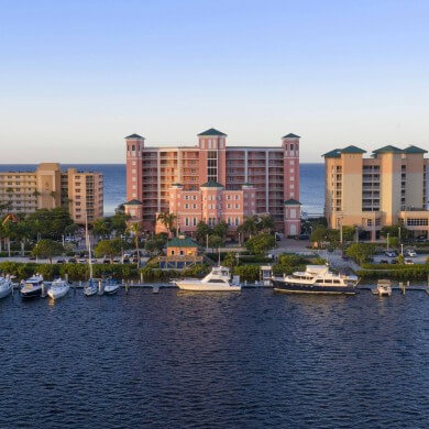 Aerial view of the Pink Shell resort building and marina in Fort Myers Beach