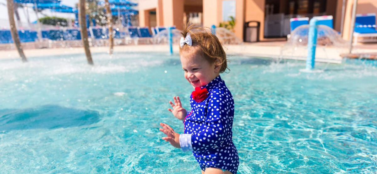 Toddler plays in the zero-entry resort pool